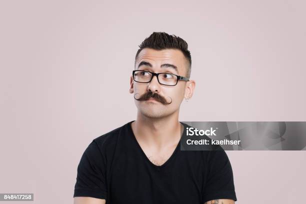 Young Man With Mustache Thinking And Staring Into Space Stock Photo - Download Image Now
