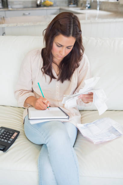 istock Woman calculating receipts 848417874