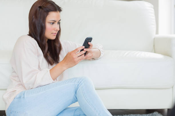 istock Brunette woman texting with her mobile phone 848418394