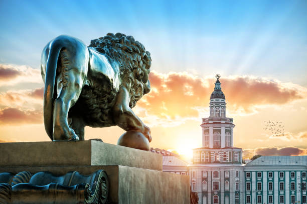 Sculpture of a lion on the Admiralteiskaya embankment in St. Petersburg opposite Kunstkamera on a summer evening