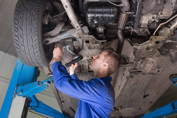 istock Repairman examining under car 848431662