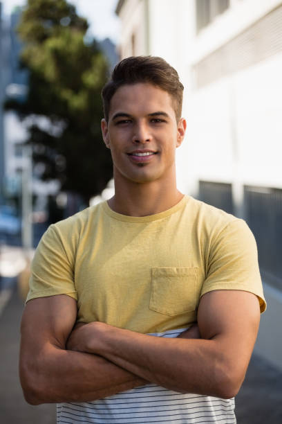 istock Handsome young man with arms crossed standing in city 848431782