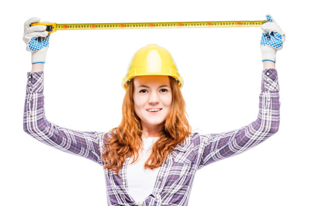 istock happy beautiful woman builder with tape measure on white background 848435626