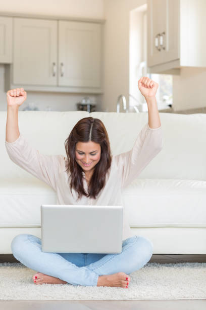 istock Woman celebrating in front of laptop 848441804