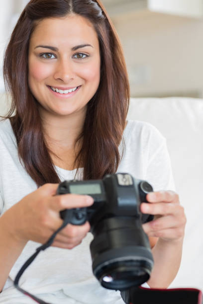 istock Brunette woman holding digital camera 848442194