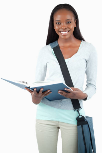 istock Smiling young student with bag reading in her book 848461104