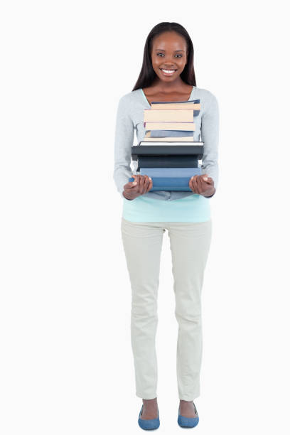 istock Smiling young woman carrying a stack of books 848461548