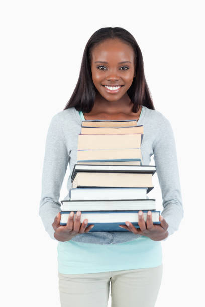 istock Smiling young woman with stack of books 848461594