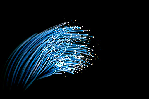 Optic fiber in blue isolated over black background