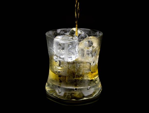 istock Glass and ice with whiskey on black background. 848471328