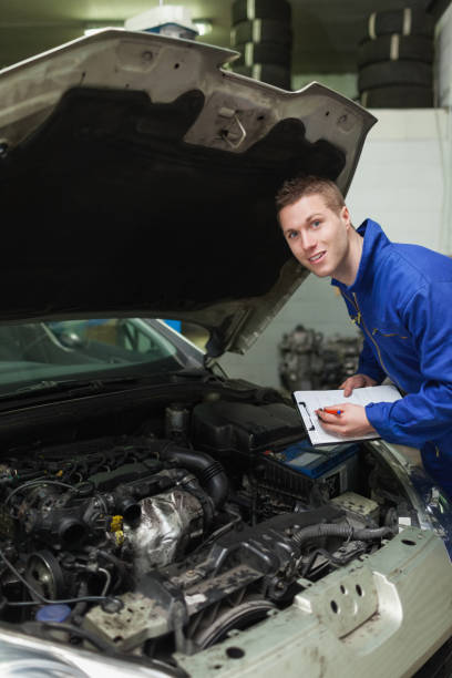 istock Auto mechanic with clipboard examining car 848481202