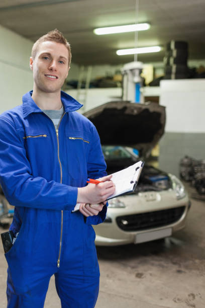 istock Happy auto mechanic writing on clipboard 848481486