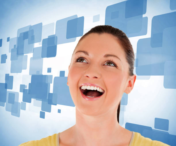 istock Woman looking up against blue background 848487870