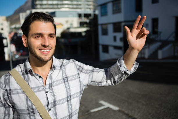 istock Smiling man gesturing while standing on city street 848488314