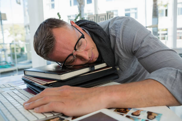 istock Tired businessman sleeping on files in studio 848491936