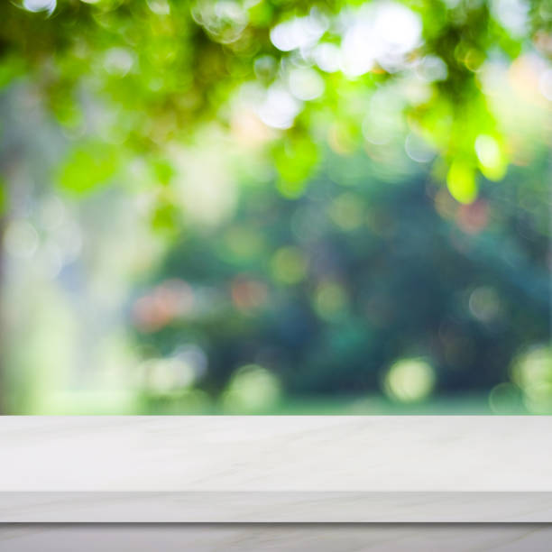 istock Empty white marble table over blur green park background, product display montage 848494944