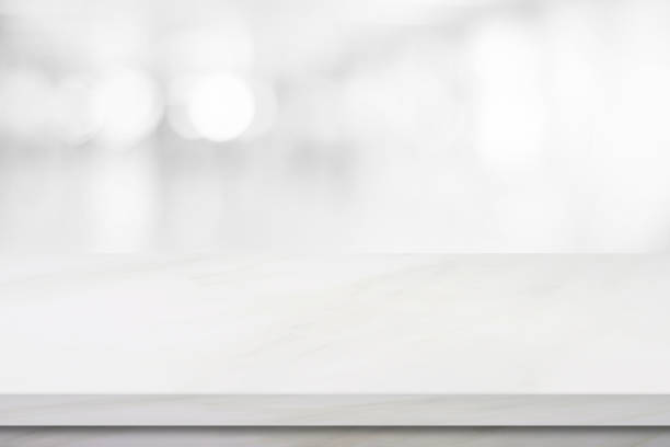 istock Empty white marble over blur store background, product and food display montage 848495088