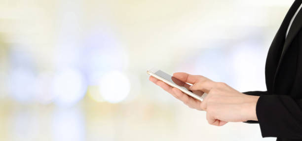 istock Businesswoman hands using smart phone over blur office with bokeh light background, banner, business on phone 848495100