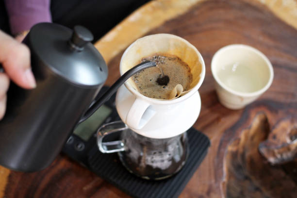 istock Barista pouring hot water over coffee grounds making  drip brew coffee. 848509162