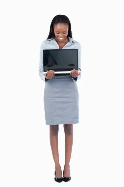 Photo of Portrait of a businesswoman showing a laptop