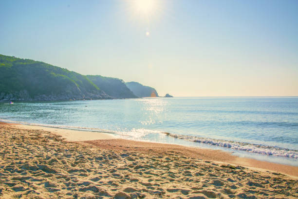 istock white beach with blue sand, clear water rolls ashore. 848539802