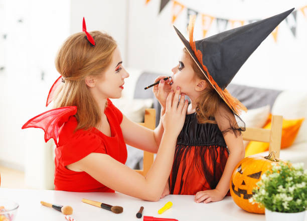 istock happy family  getting ready for halloween make make-up 848545852