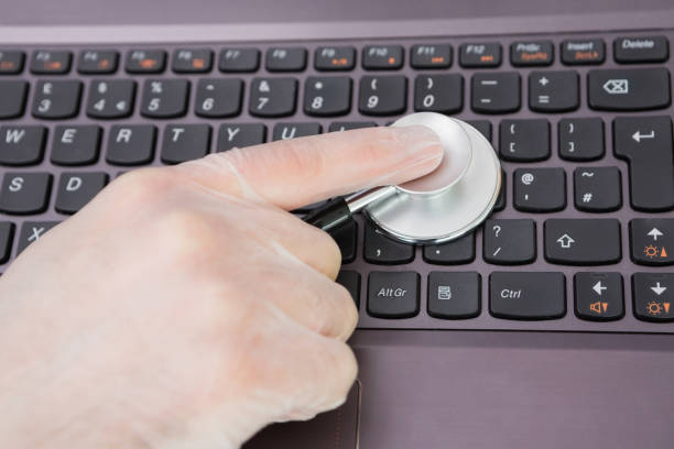 istock Hand examining laptop keyboard with stethoscope 848557134