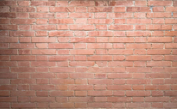 istock Weathered texture of stained old light brown and red brick wall 848567390