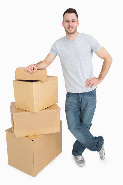 istock Portrait of smiling young man with cardboard boxes 848580892