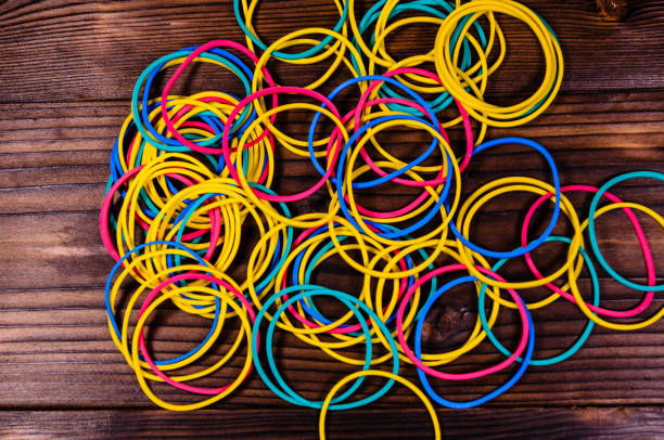 istock Multicolored rubber bands on wooden table. Top view 848580972