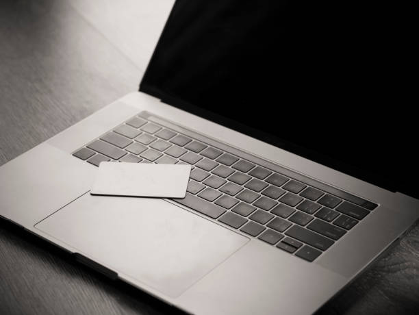 istock One blank white credit cards on the computer keyboard 848584130