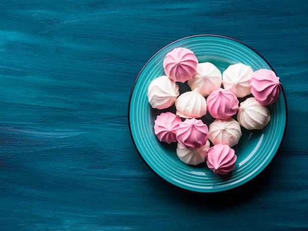 istock Pastel color meringue on green 848584140