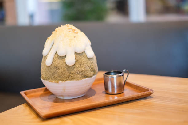 istock Hojicha kakigori (Japanese shaved ice dessert flavor with white cream) serve on white bowl with Kuromitsu sauce. 848584692