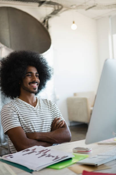 istock Smiling man sitting at desk in office 848588798