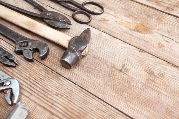 istock Composition of construction tools on an old battered wooden surface of tools: pliers, pipe wrench, screwdriver, hammer, metal shears, saws 848592118