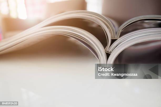 Pile Of Magazines Stack On White Table In Living Room Stock Photo - Download Image Now