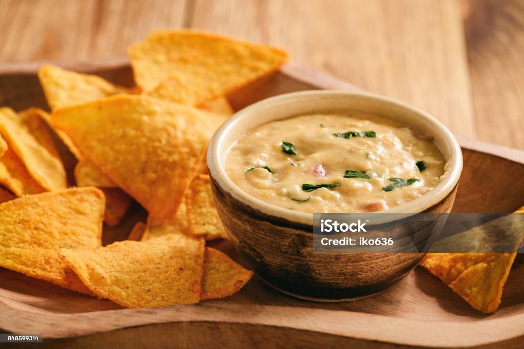 Mexican cheese dip served with nachos. Cream - Dairy Product Stock Photo
