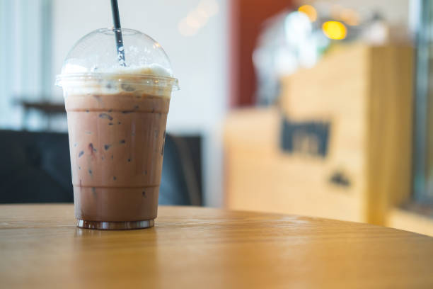 istock Iced coffee in take away cup (plastic glass) on the wood table in cafe 848616112
