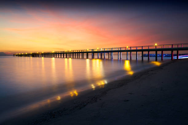 istock Illuminated wooden bridge on a beach 848619444