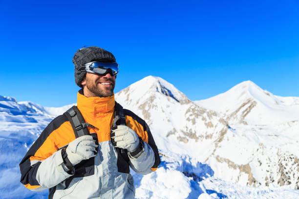 istock Male backpacker hiking in snow mountain 848619622