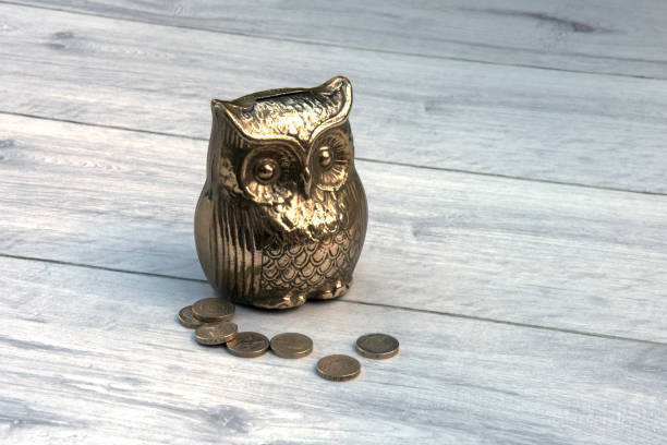 istock Brass money box with old one pound coins. 848624434