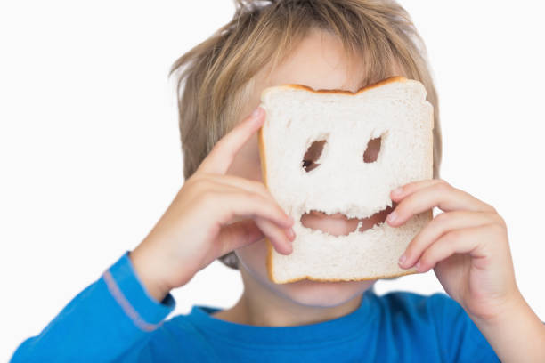istock Young boy looking through holes in bread slice 848624472