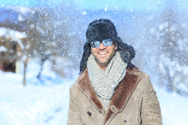istock Portrait of smiling young man having fun on snow mountain 848624498