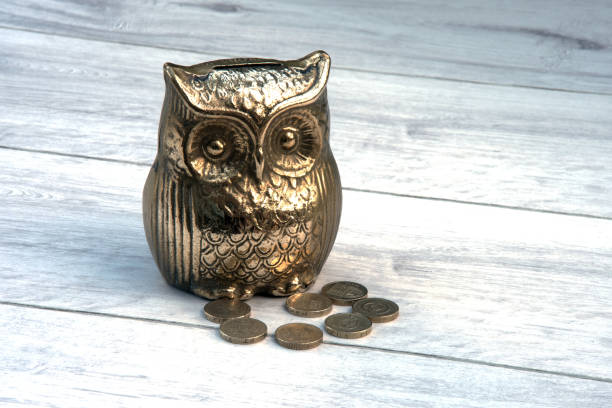 istock Brass money box with old one pound coins. 848624686