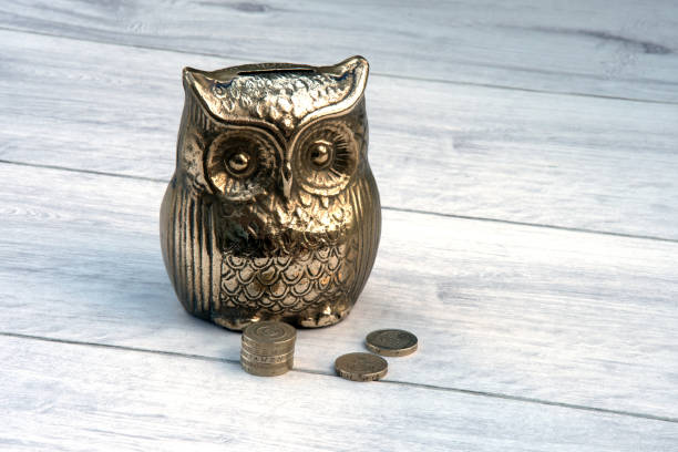 istock Brass money box with old one pound coins. 848625040
