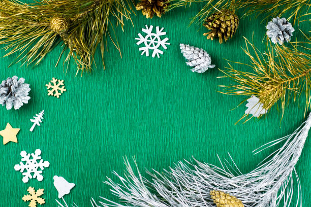 istock Christmas frame with fir tree branches, pine cones, silver and golden ornaments on warm green background, copy space. 848631454
