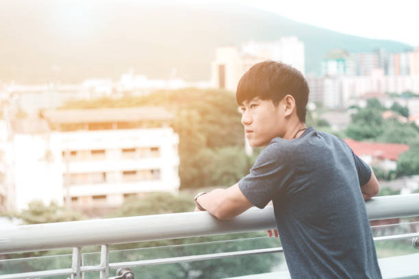 istock Lonely men are looking city view and sunset 848634664