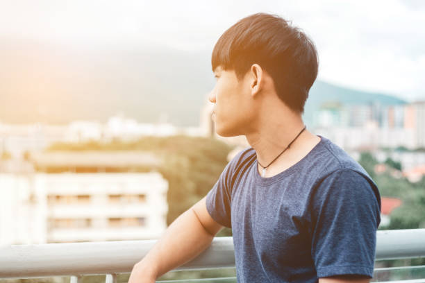 istock Lonely men are looking city view and sunset 848634730