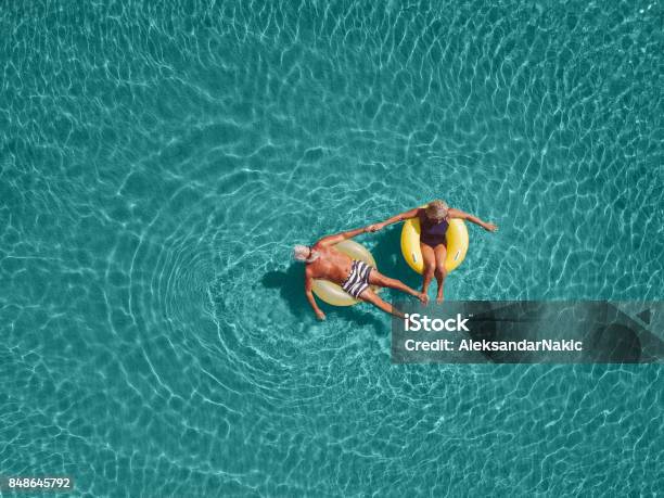 Senior Couple Enjoy Sea Water Stock Photo - Download Image Now - Senior Adult, Vacations, Summer