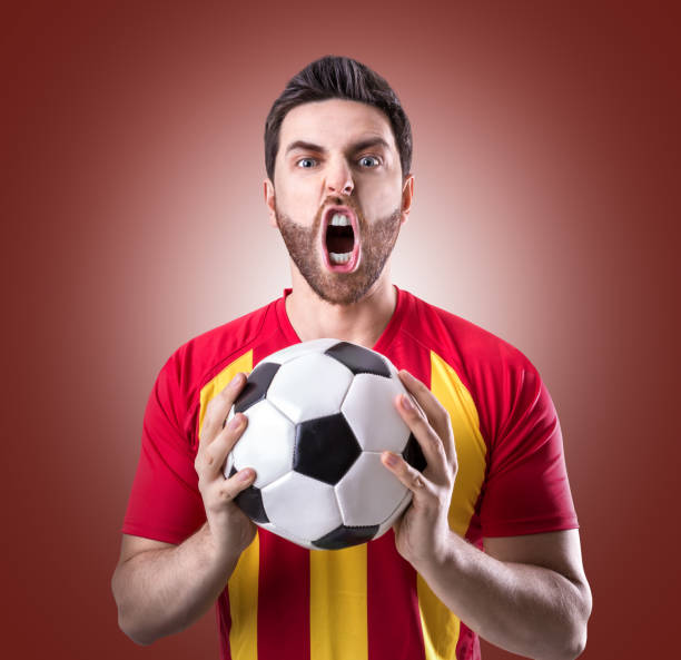 istock Fan / Player celebrating in red and yellow uniform 848650278